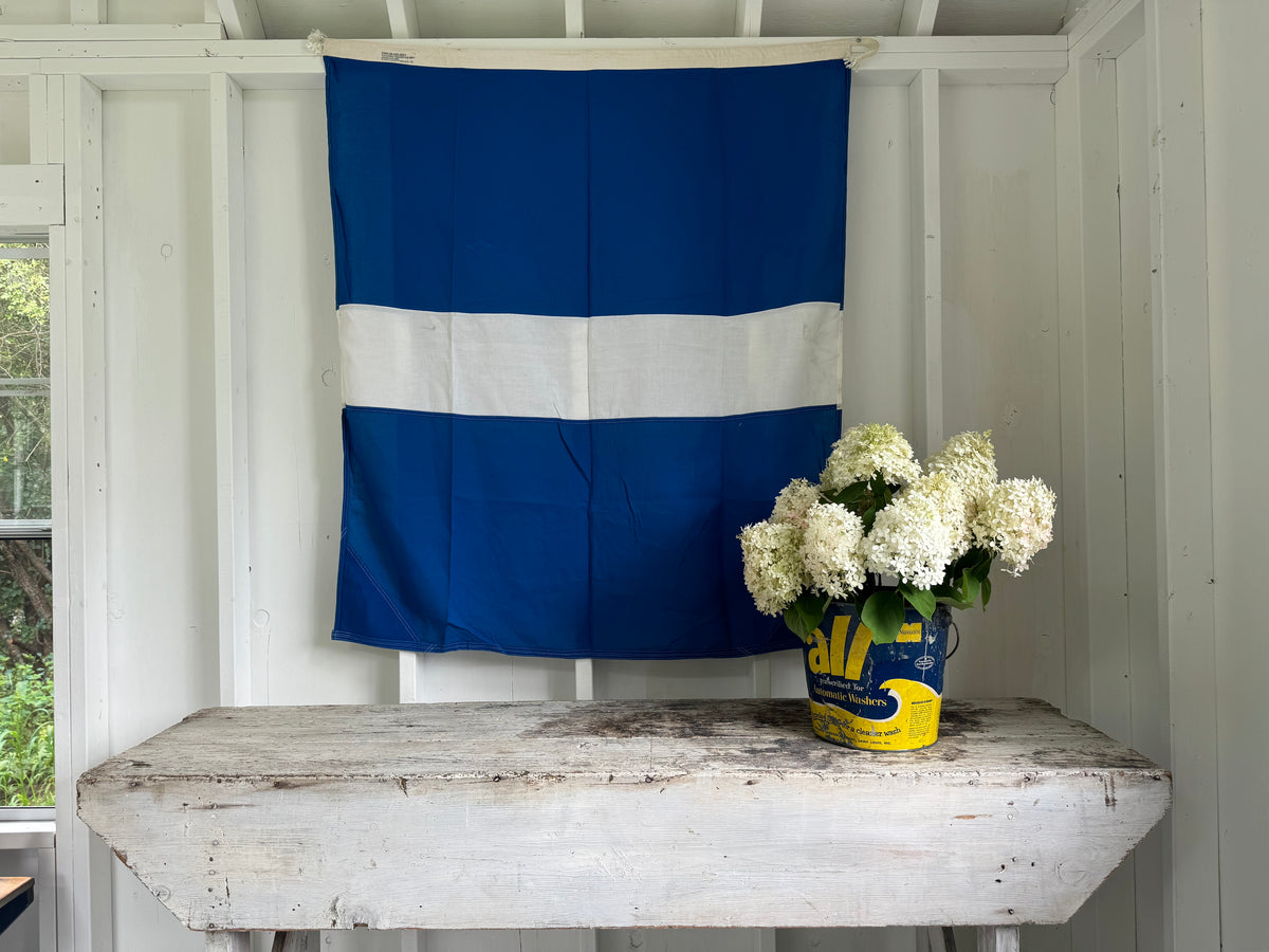 photos of a vintage workbench and a vintage laundry pail filled with hydrangeas