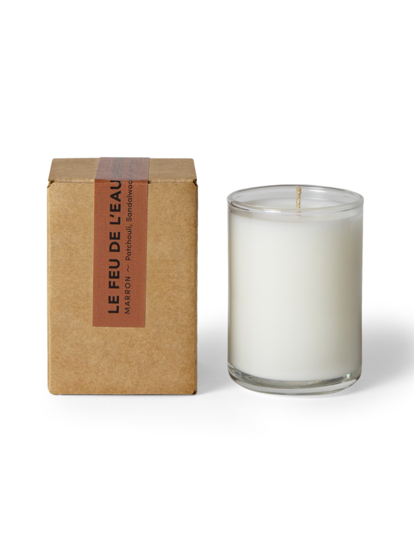 Glass candle with a cardboard box labeled 'Le Feu de L'Eau' on a white background